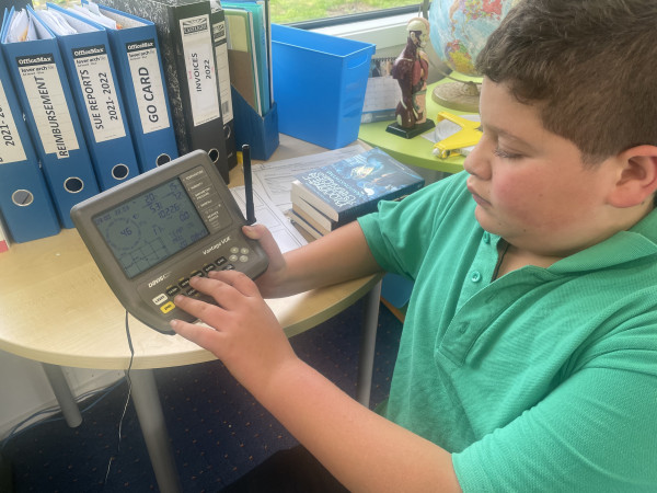Liam Tuhiwai-Rogers setting the indoor screen in the classroom.